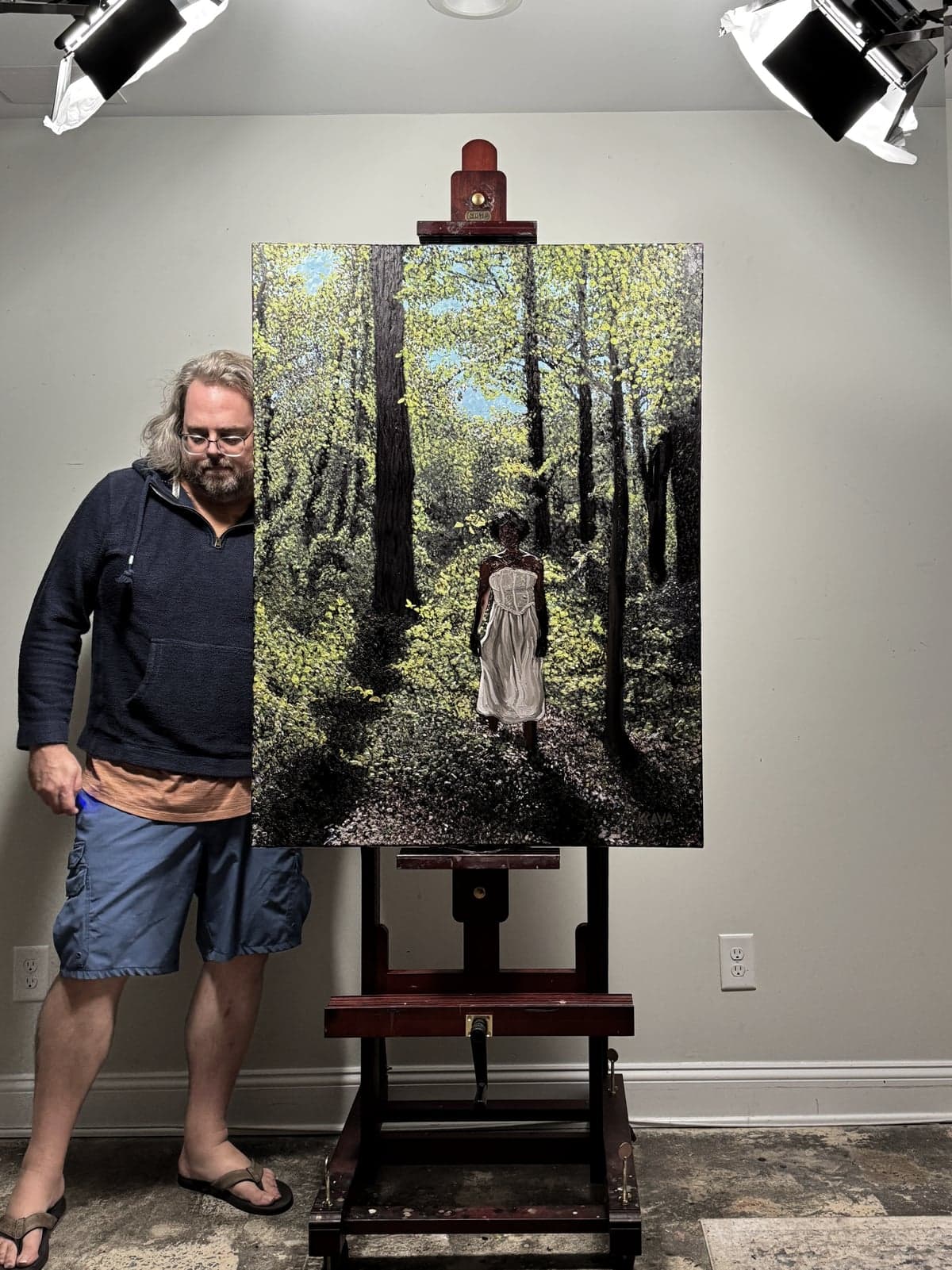 Kris Krava holding a painting